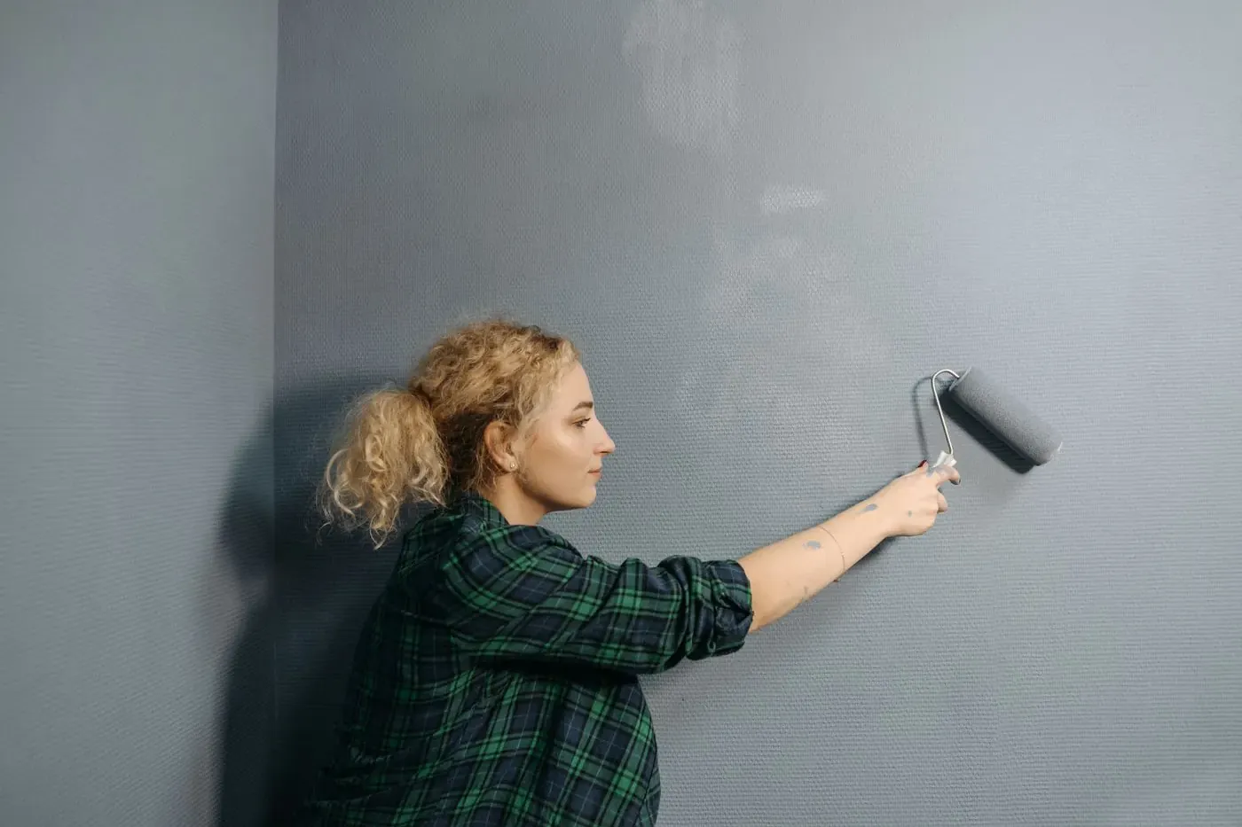 Profesional pintando la pared de una vivienda en obras